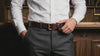 Men’s full grain leather belt worn on the waist in close-up